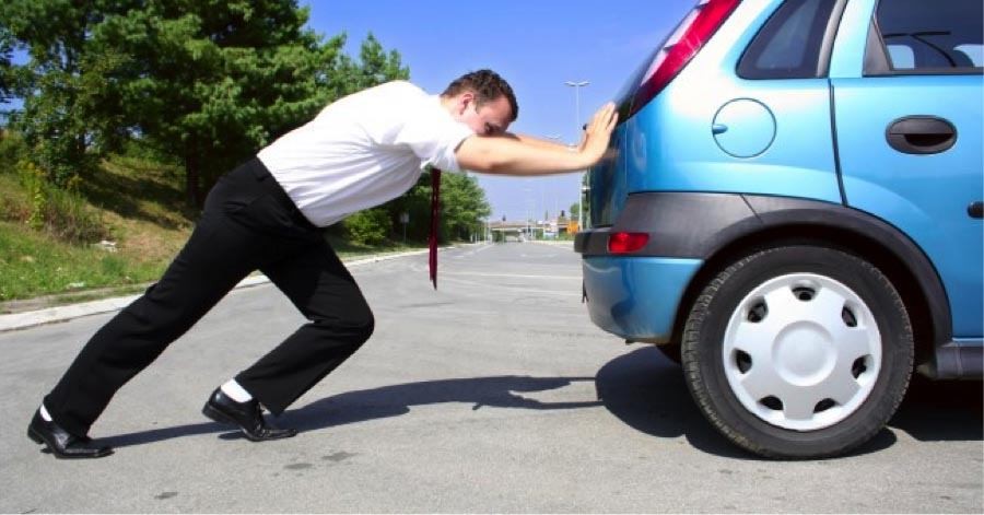 person pushing a car