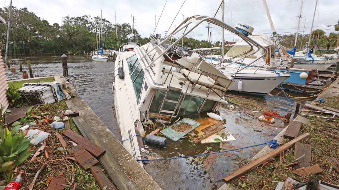 a wrecked boat tied to a dock