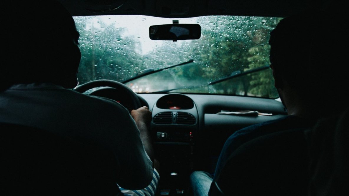 two people driving in a car